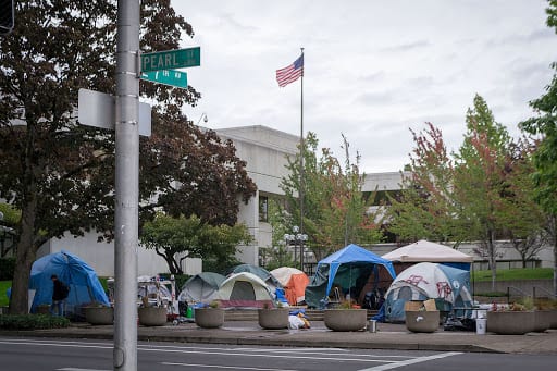 Image Description: tent encampment in the plaza of a Federal Building